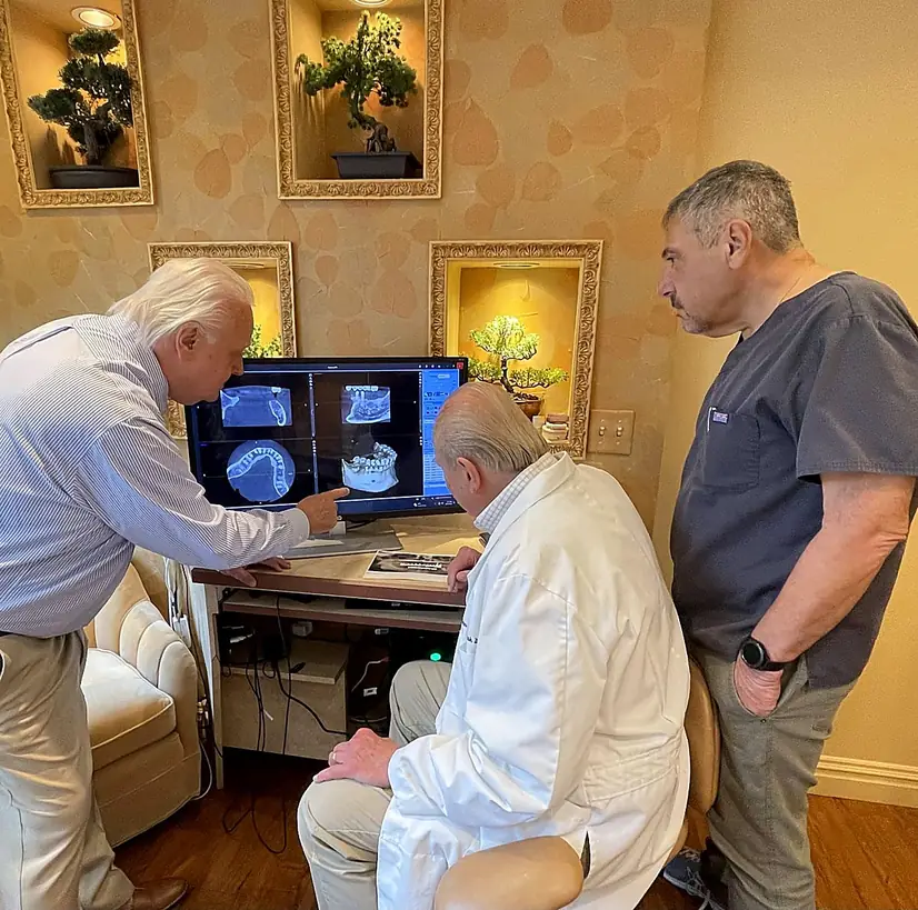 Dr. Kurpis reviewing implant radiographs with a colleague.